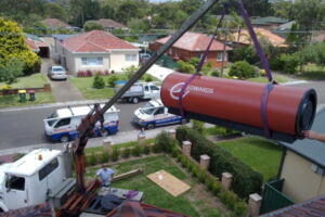 Crane lifting a hot water system